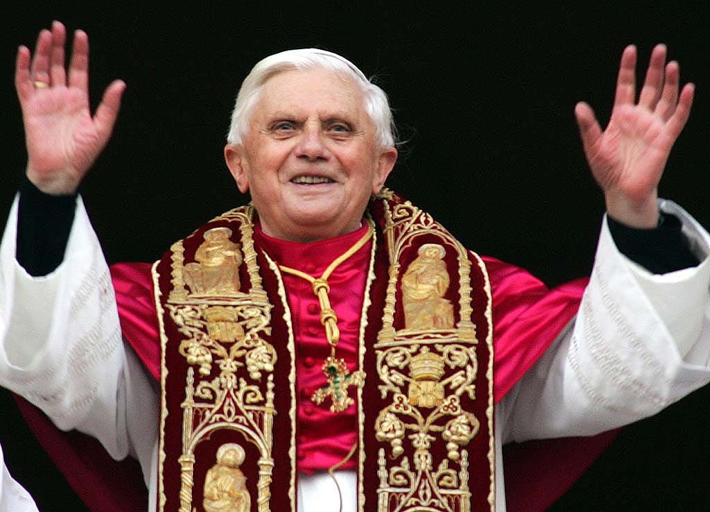 Newly elected Pope Joseph Ratzinger of Germany waves to the crowd from the central balcony of St. Peter's Basilica, at the Vatican, Tuesday, April 19, 2005. (AP Photo/ Andrew Medichini)